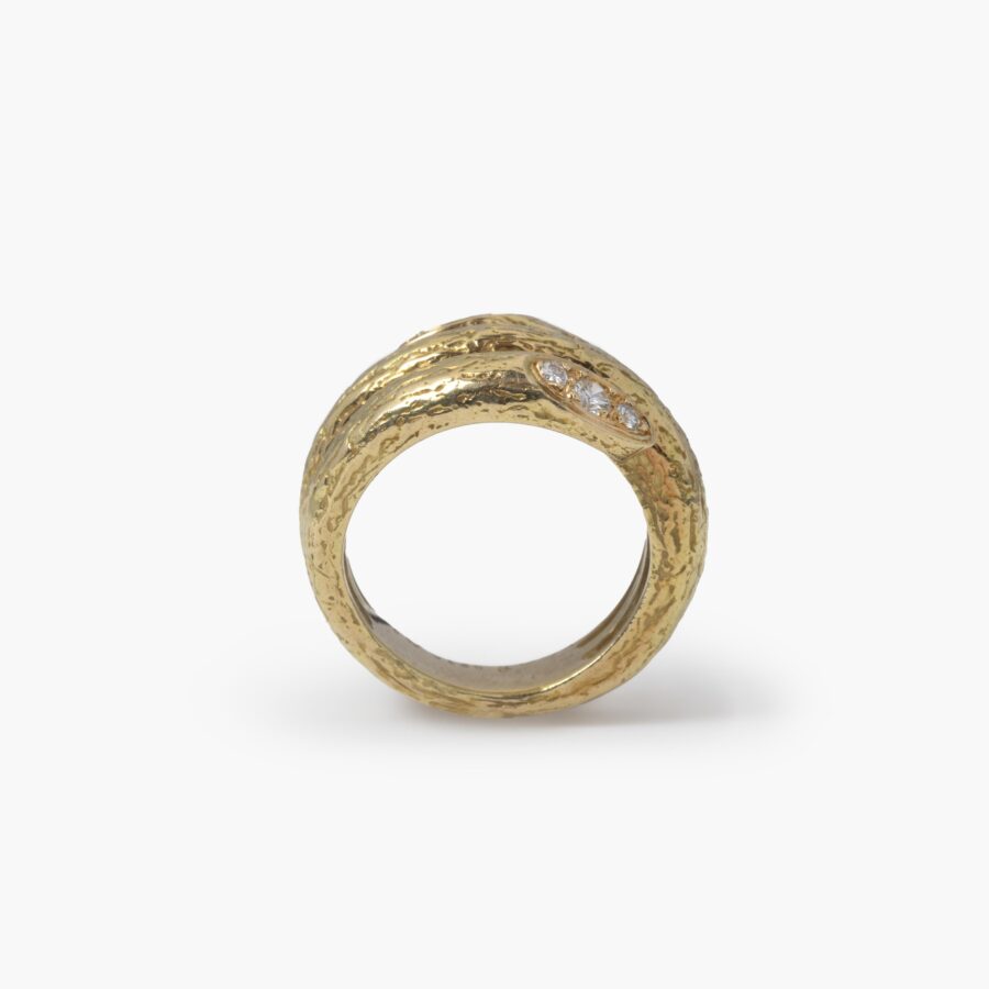 An eighteen carat yellow gold ring designed as two windings, with a textured surface. Signed Van Cleef & Arpels, made in Paris, made ca 1970 and numbered.
