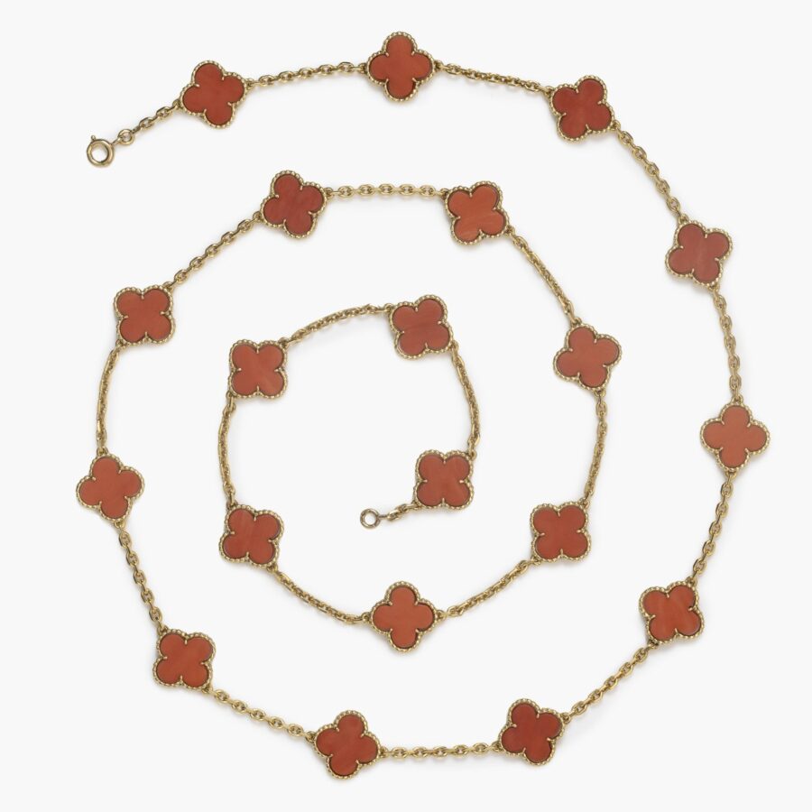 An eighteen carat yellow gold “Alhambra” longchain made of twenty coral “Alhambra” motifs. Signed Van Cleef & Arpels and numbered, made in Paris in 1977.