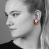 A pair of eighteen carat yellow gold clip earrings and matching ring, all set with coral, diamonds and green agate, signed Van Cleef & Arpels, Paris.