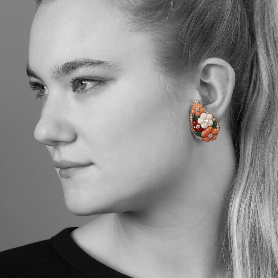 A pair of eighteen carat yellow gold clip earrings and matching ring, all set with coral, diamonds and green agate, signed Van Cleef & Arpels, Paris.
