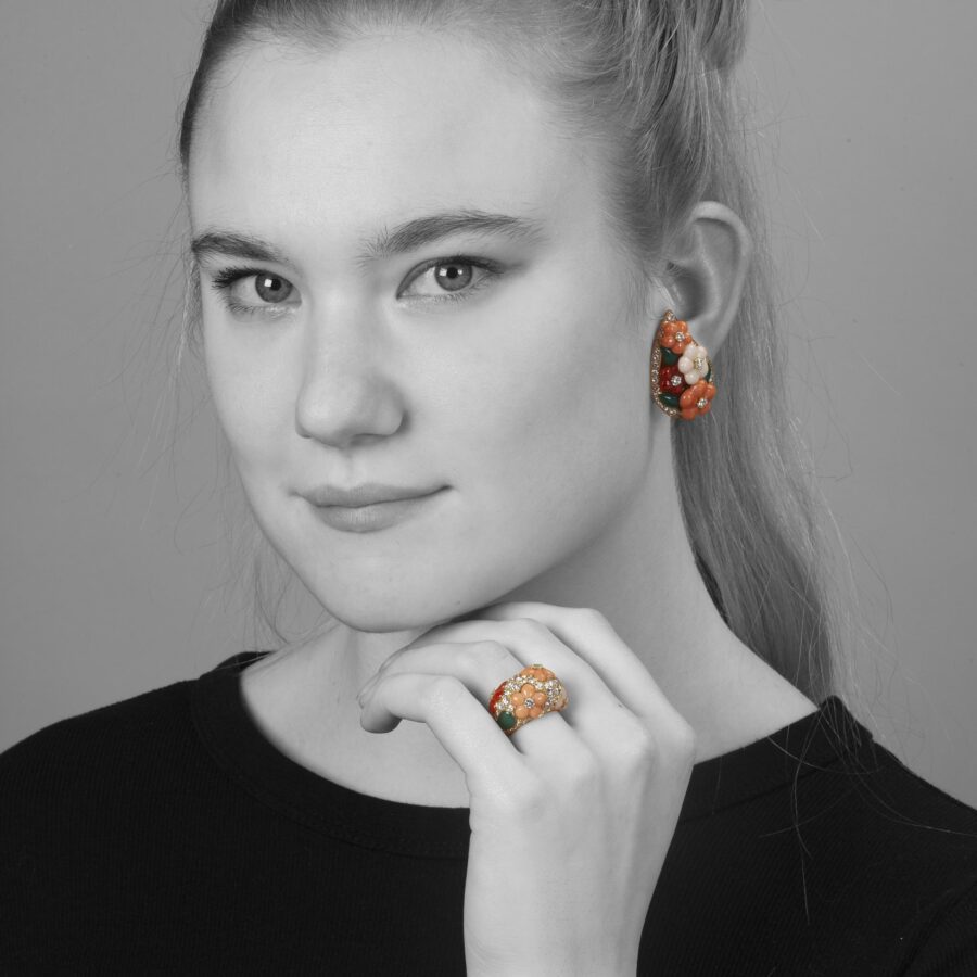 A pair of eighteen carat yellow gold clip earrings and matching ring, all set with coral, diamonds and green agate, signed Van Cleef & Arpels, Paris.