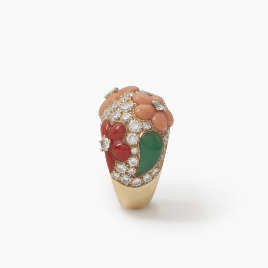 A pair of eighteen carat yellow gold clip earrings and matching ring, all set with coral, diamonds and green agate, signed Van Cleef & Arpels, Paris.