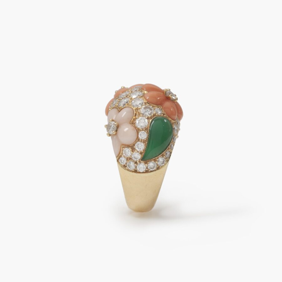 A pair of eighteen carat yellow gold clip earrings and matching ring, all set with coral, diamonds and green agate, signed Van Cleef & Arpels, Paris.