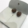 A pair of eighteen carat red gold and copper oval bombé clip earrings, pavé set with brilliant cut brown diamonds. Signed Hemmerle, made in Munich.