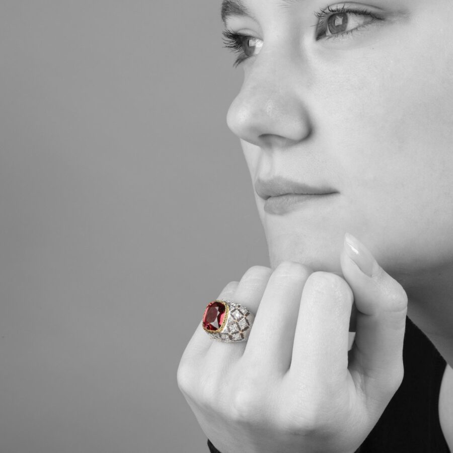 An eighteen carat white and yellow gold ring set with a orange-pink tourmaline and brilliant cut diamonds. Signed M. Buccellati, made in Milan, ca 1965.