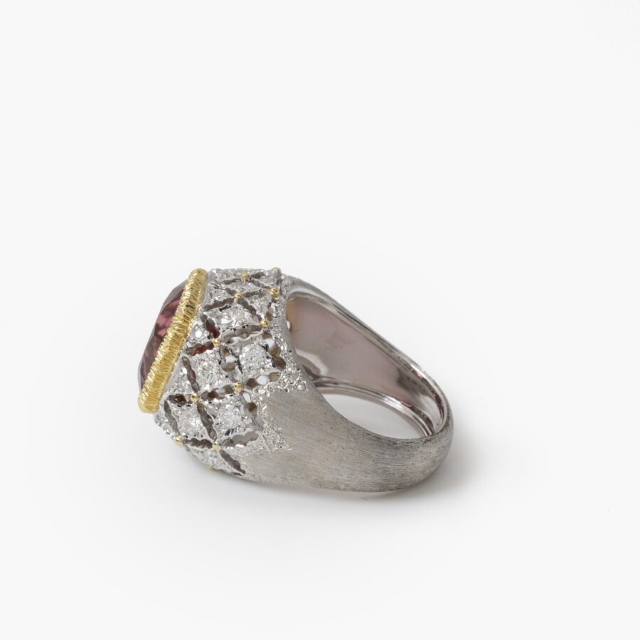 An eighteen carat white and yellow gold ring set with a orange-pink tourmaline and brilliant cut diamonds. Signed M. Buccellati, made in Milan, ca 1965.