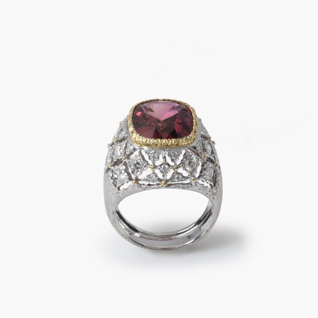 An eighteen carat white and yellow gold ring set with a orange-pink tourmaline and brilliant cut diamonds. Signed M. Buccellati, made in Milan, ca 1965.