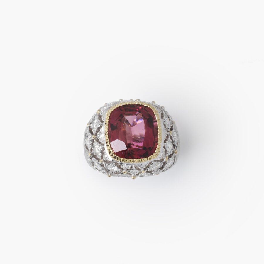 An eighteen carat white and yellow gold ring set with a orange-pink tourmaline and brilliant cut diamonds. Signed M. Buccellati, made in Milan, ca 1965.