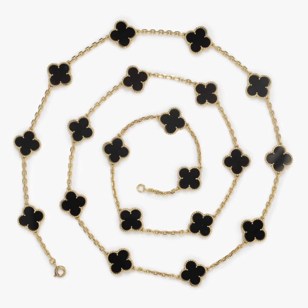 An eighteen carat yellow gold “Alhambra” longchain set with onyx. Signed Van Cleef & Arpels, and numbered. Made in Paris, ca 1970.