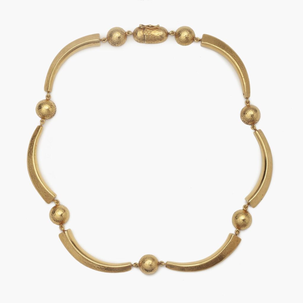 An eighteen carat yellow gold necklace with hammered texture, comprising cresents an half domes. Signed Ilias Lalaounis, made in Athens, Greec