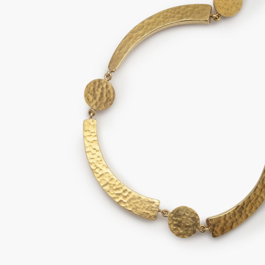 An eighteen carat yellow gold necklace with hammered texture, comprising cresents an half domes. Signed Ilias Lalaounis, made in Athens, Greec