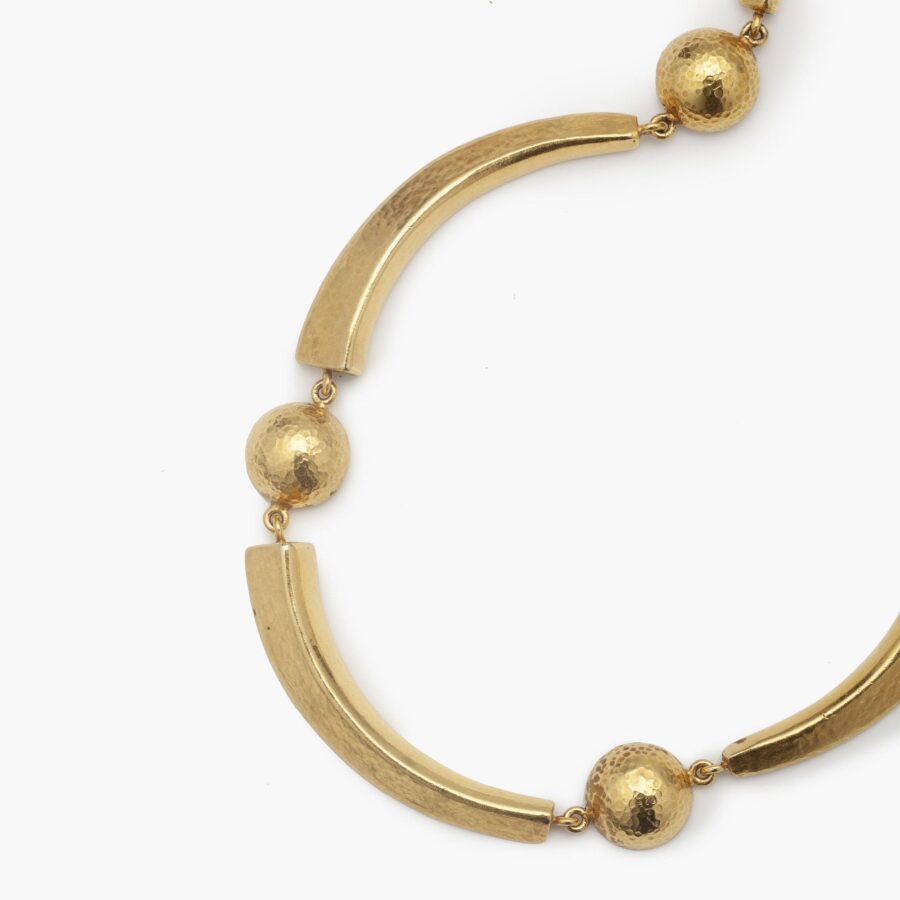 An eighteen carat yellow gold necklace with hammered texture, comprising cresents an half domes. Signed Ilias Lalaounis, made in Athens, Greec