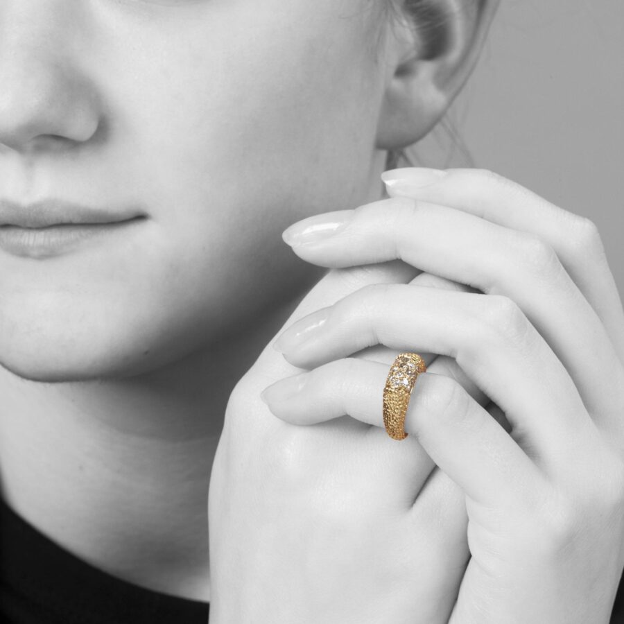 An eighteen carat yellow gold ring of bombé design “Philippine”, set with diamonds and with etched texture. Signed Van Cleef & Arpels, Paris, dated 1969.