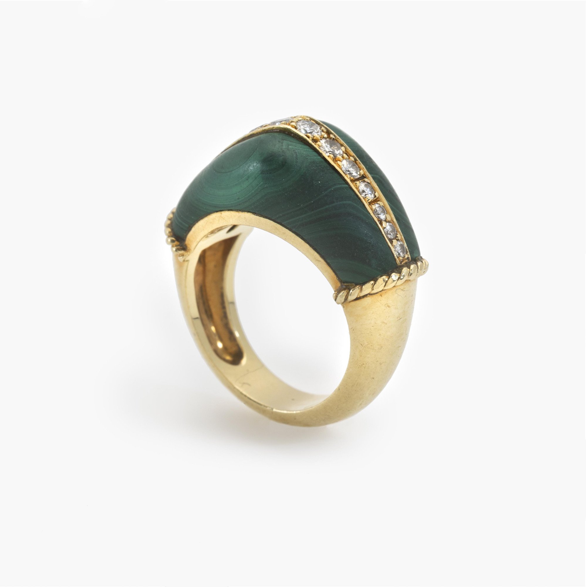 An eighteen-karat yellow gold ring set with malachite and brilliant-cut diamonds. Signed Cartier and numbered, made in Paris, circa 1980.