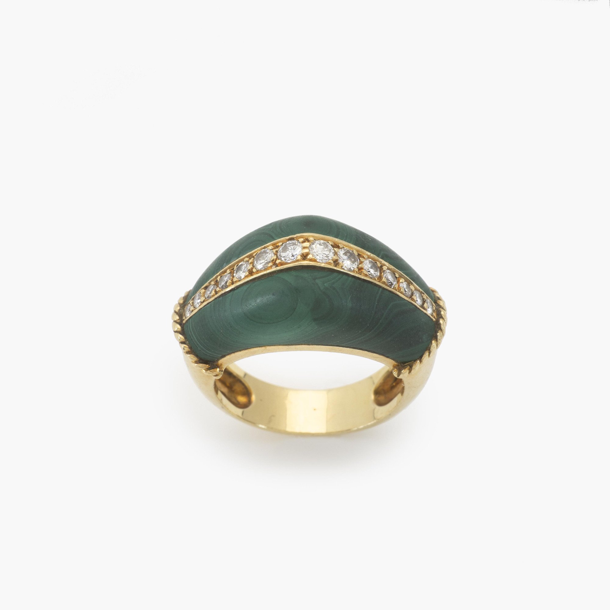 An eighteen-karat yellow gold ring set with malachite and brilliant-cut diamonds. Signed Cartier and numbered, made in Paris, circa 1980.