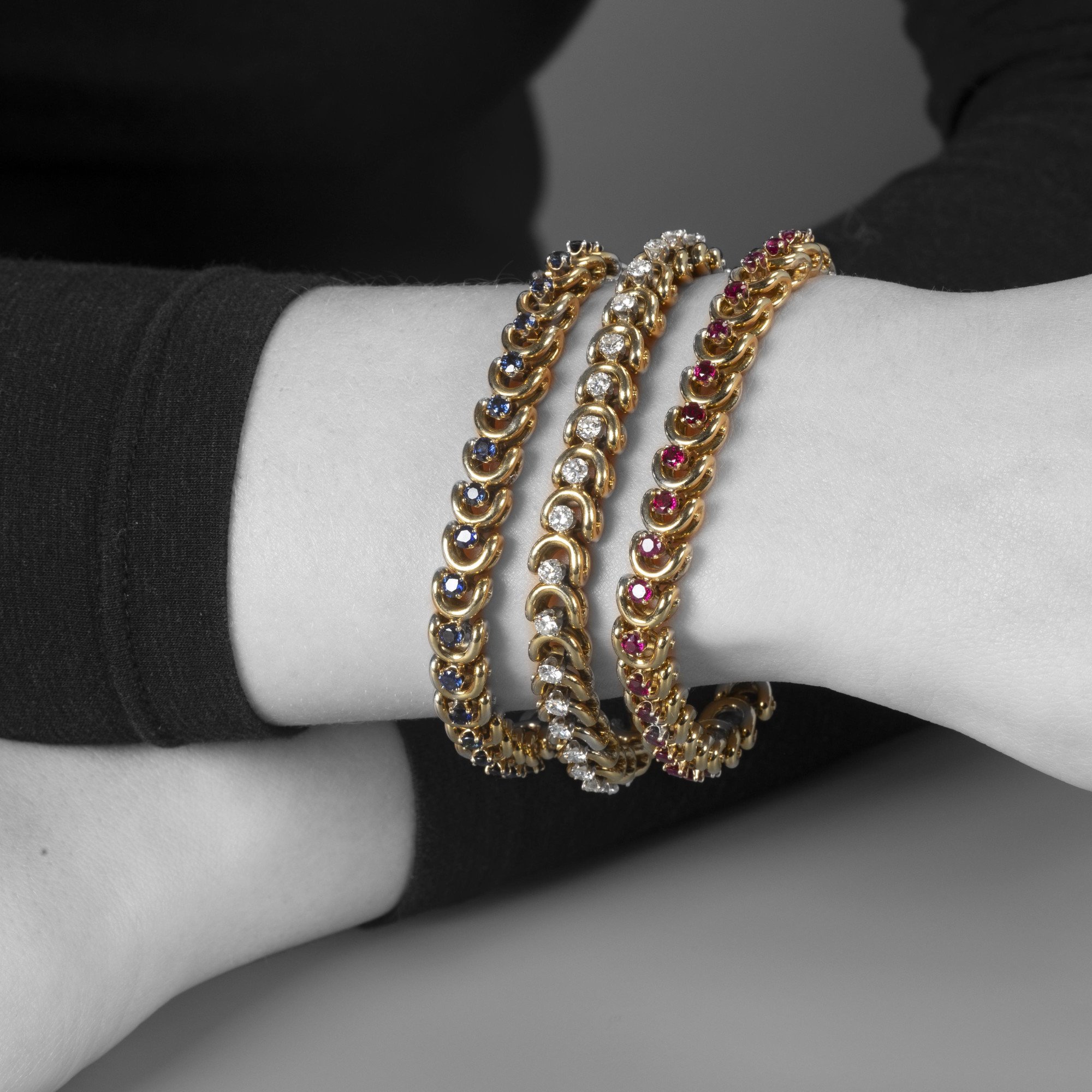 A set of three identical eighteen-carat yellow gold bracelets, set with sapphires, diamonds and rubies. Van Cleef & Arpels, New York, with original box.