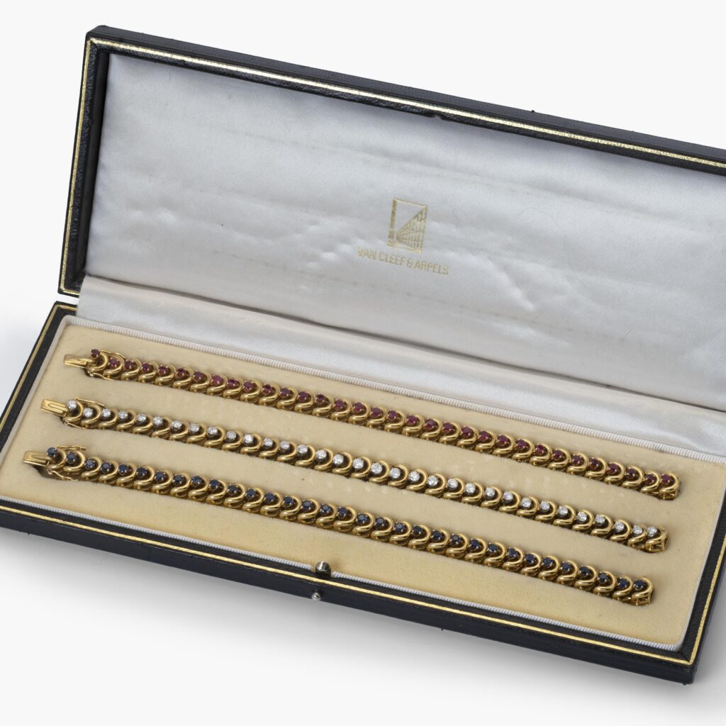 A set of three identical eighteen-carat yellow gold bracelets, set with sapphires, diamonds and rubies. Van Cleef & Arpels, New York, with original box.