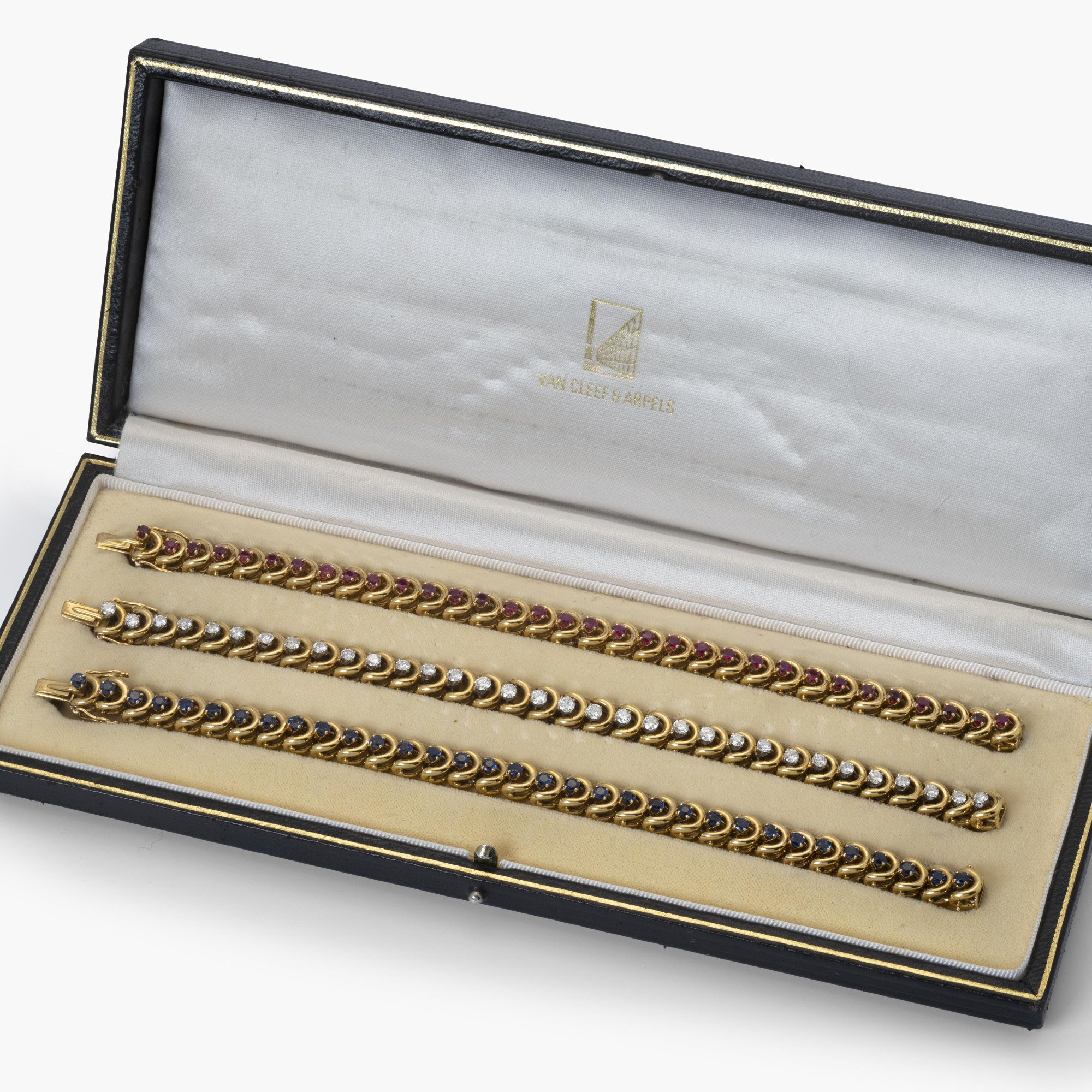 A set of three identical eighteen-carat yellow gold bracelets, set with sapphires, diamonds and rubies. Van Cleef & Arpels, New York, with original box.