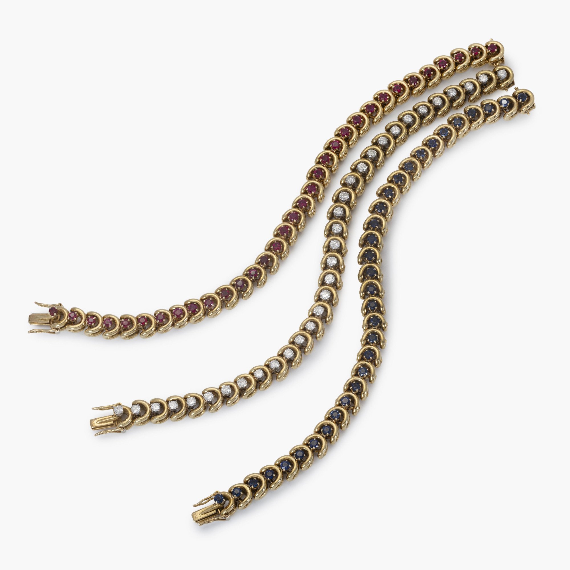 A set of three identical eighteen-carat yellow gold bracelets, set with sapphires, diamonds and rubies. Van Cleef & Arpels, New York, with original box.