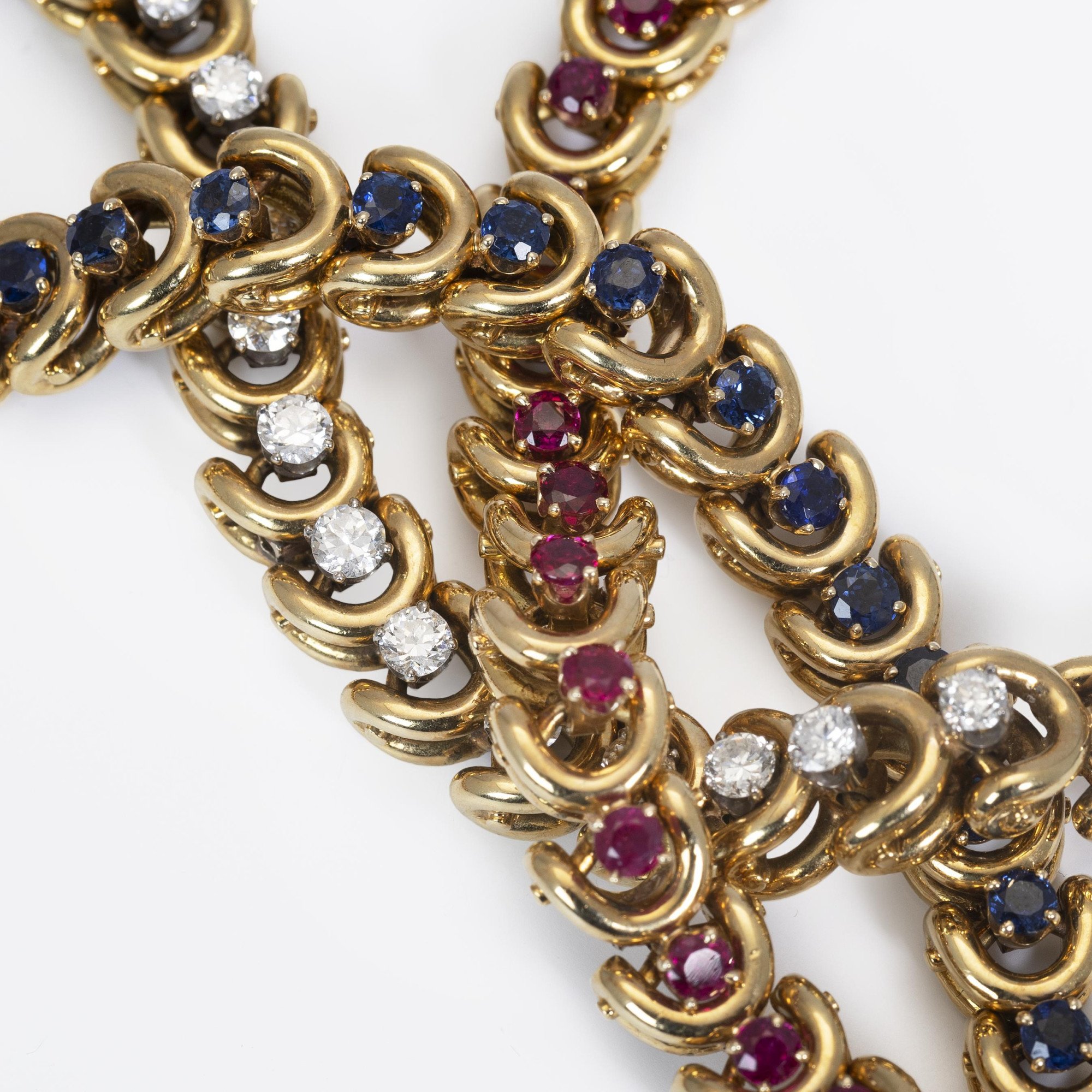 A set of three identical eighteen-carat yellow gold bracelets, set with sapphires, diamonds and rubies. Van Cleef & Arpels, New York, with original box.