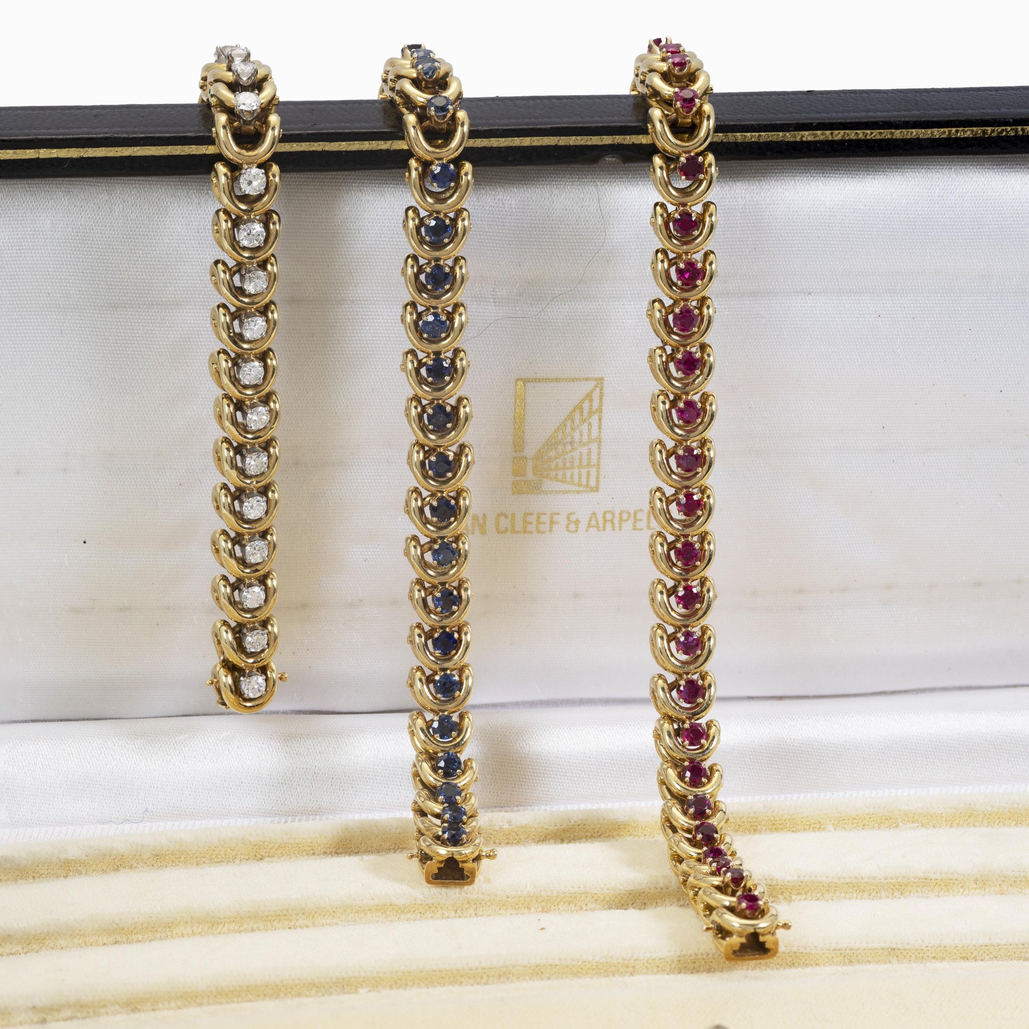A set of three identical eighteen-carat yellow gold bracelets, set with sapphires, diamonds and rubies. Van Cleef & Arpels, New York, with original box.