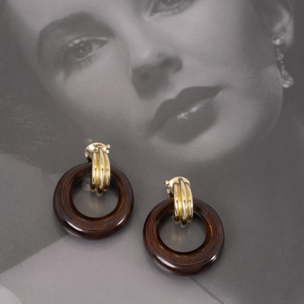 A pair of eighteen-carat yellow gold clip earrings with wooden hoops. Signed Van Cleef & Arpels, Paris, dated 1969. Former collection Elizabeth Taylor.