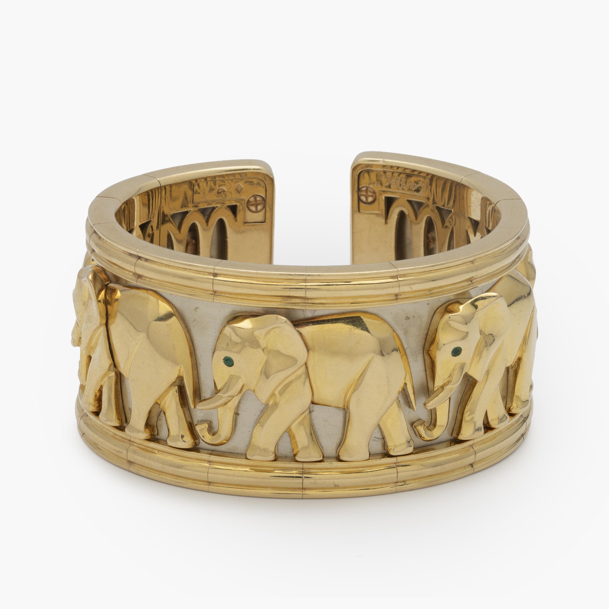 An eighteen-carat yellow and white gold “Djigar” cuff bracelet decorated with elephants. Signed Cartier, made in Paris in 1992, numbered. In original case.