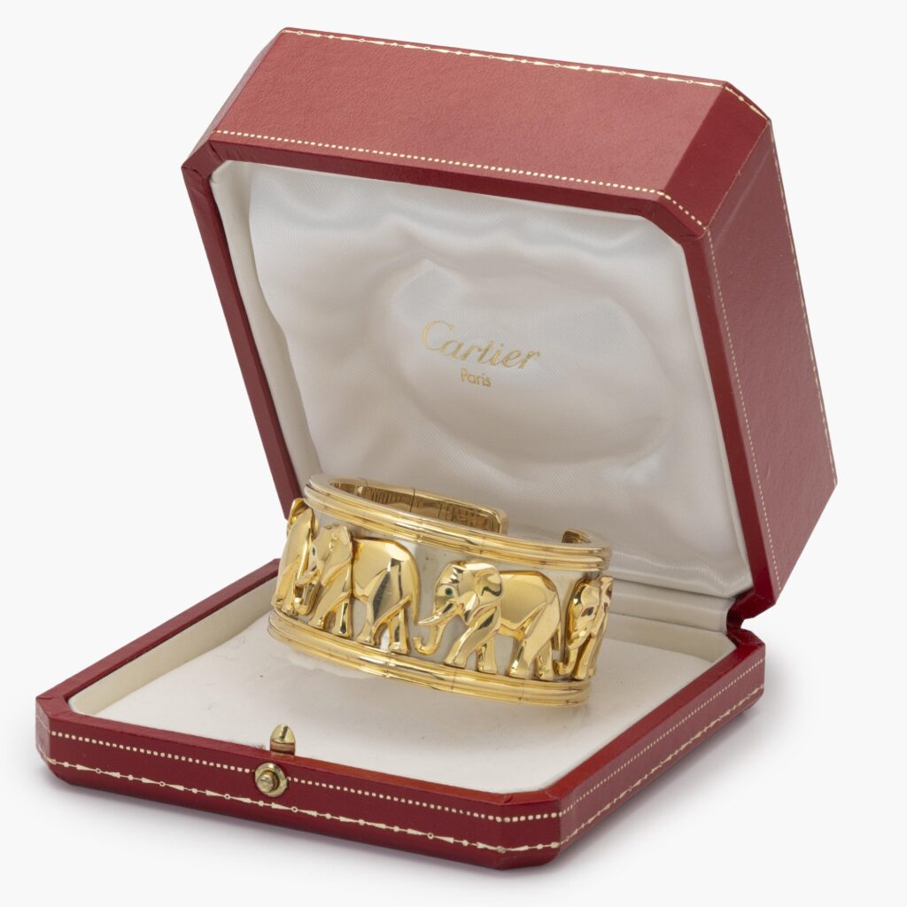 An eighteen-carat yellow and white gold “Djigar” cuff bracelet decorated with elephants. Signed Cartier, made in Paris in 1992, numbered. In original case.