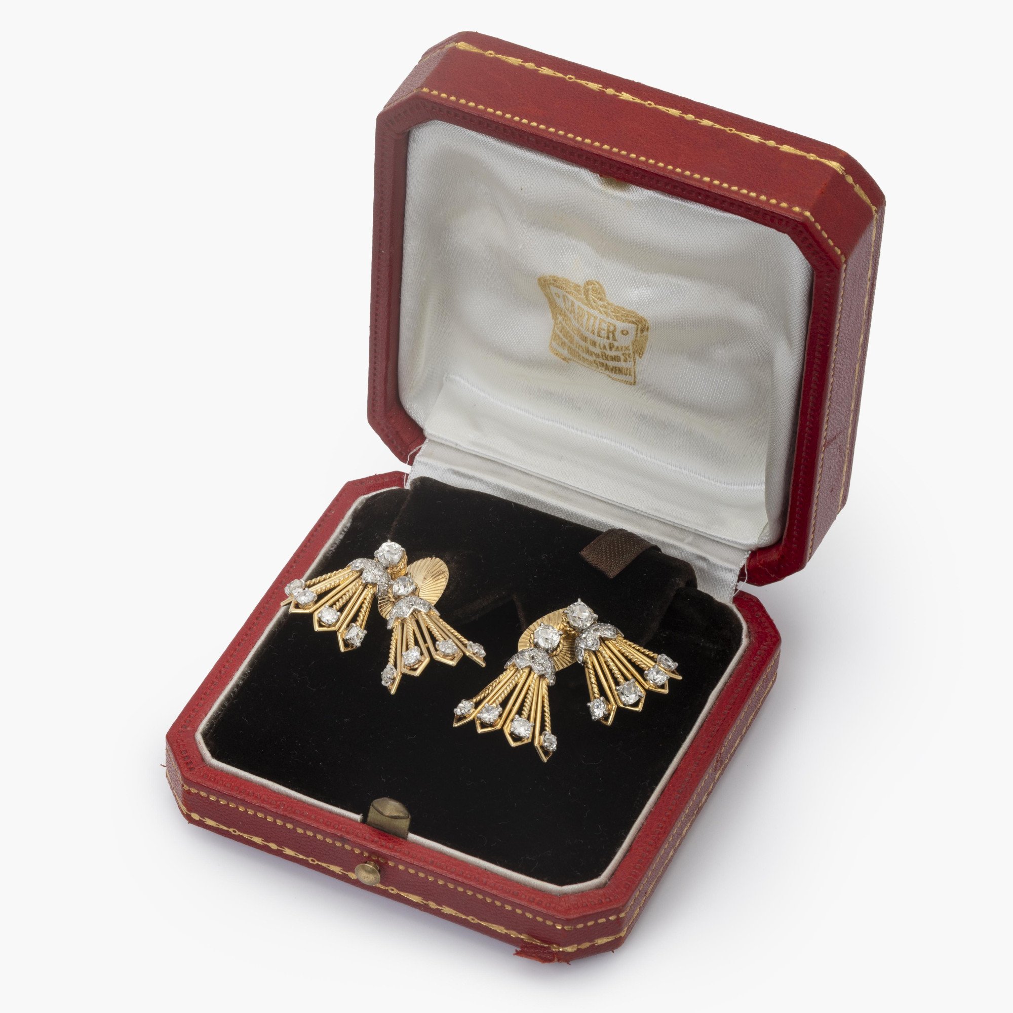 A pair of eighteen carat yellow gold and platinum earrings, each with rotating tassels. Signed Monture Cartier, Paris, circa 1950.