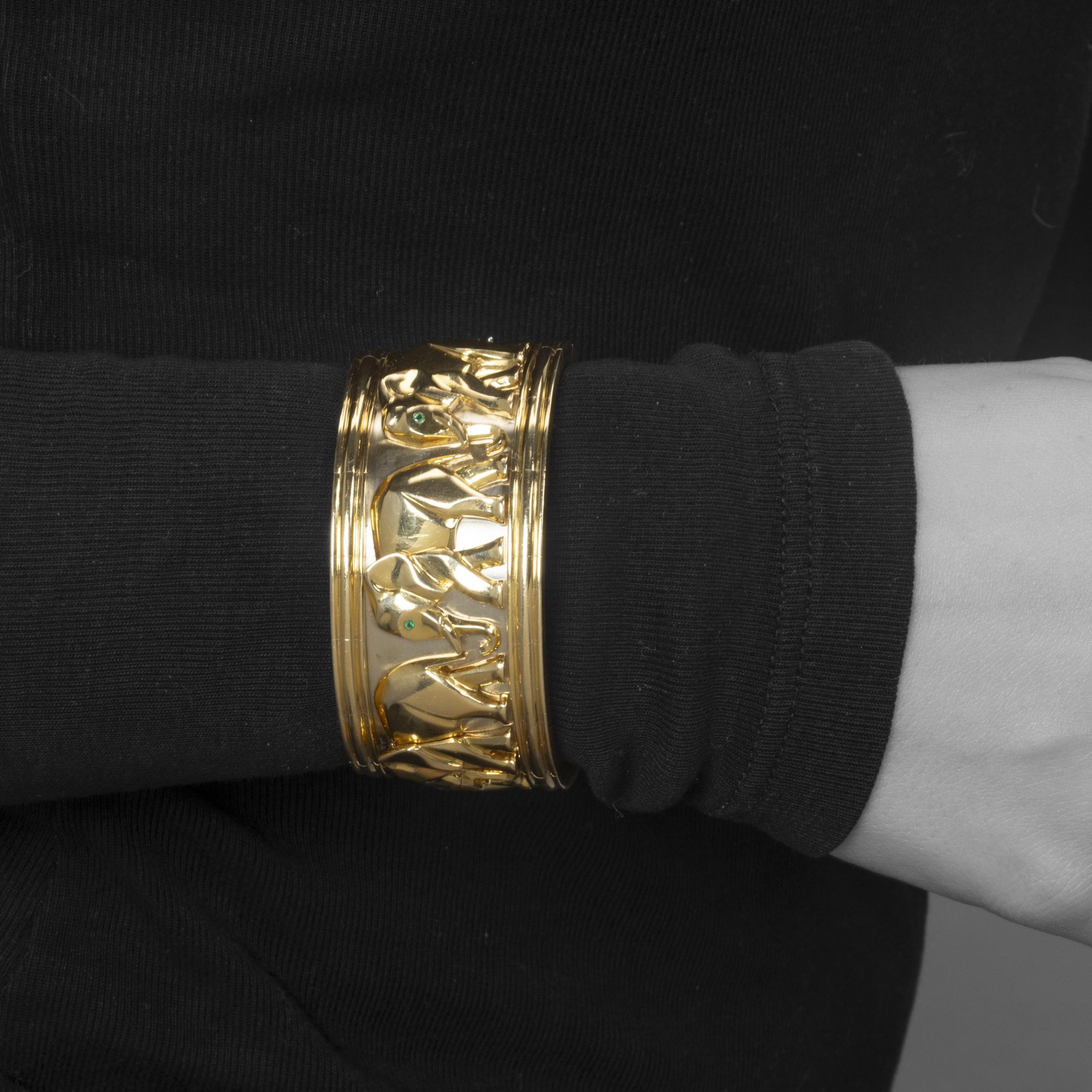 An eighteen-carat yellow and white gold “Djigar” cuff bracelet decorated with elephants. Signed Cartier, made in Paris in 1992, numbered. In original case.