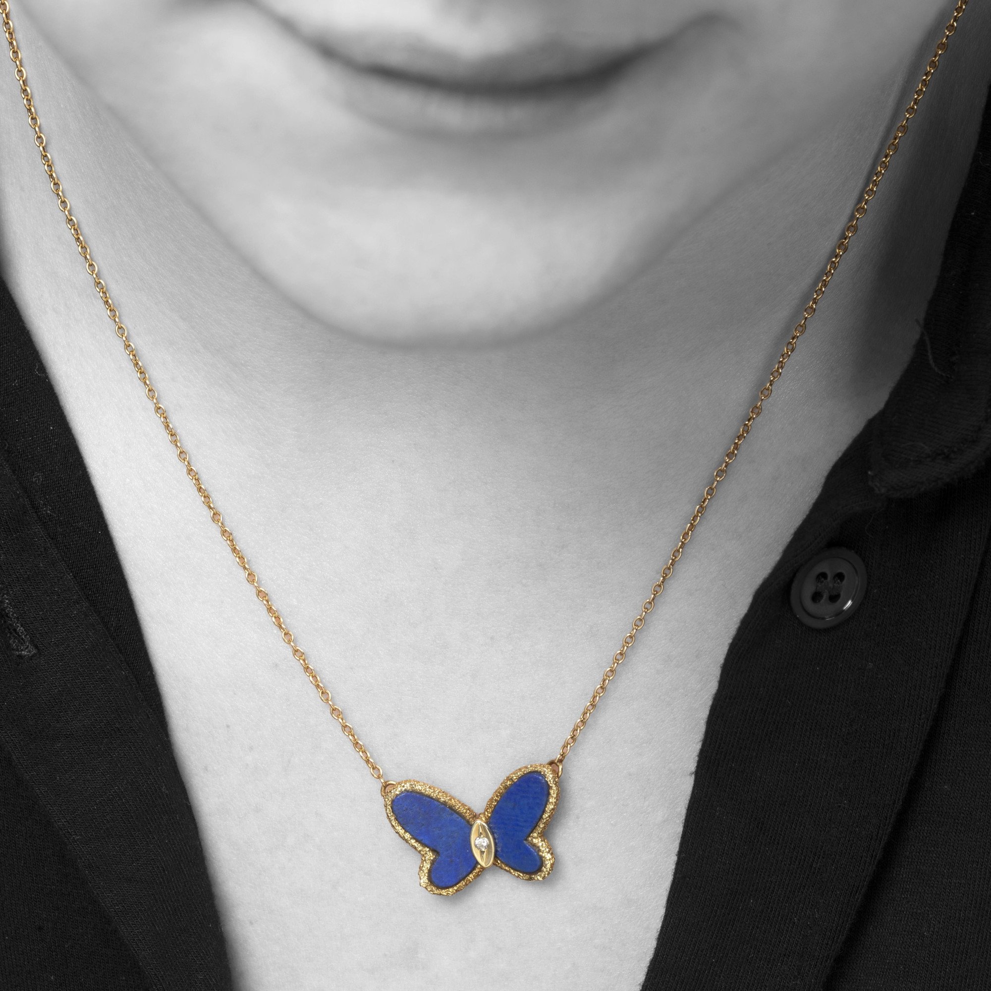 An eighteen carat yellow gold pendant designed as a butterfly carved from lapis lazuli. Signed Van Cleef & Arpels, Paris, ca 1970. With original pouch.