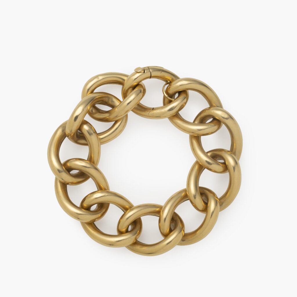 An eighteen carat yellow gold curb chain bracelet comprising eleven links. Signed Cartier Paris and numbered. Made ca 1960.