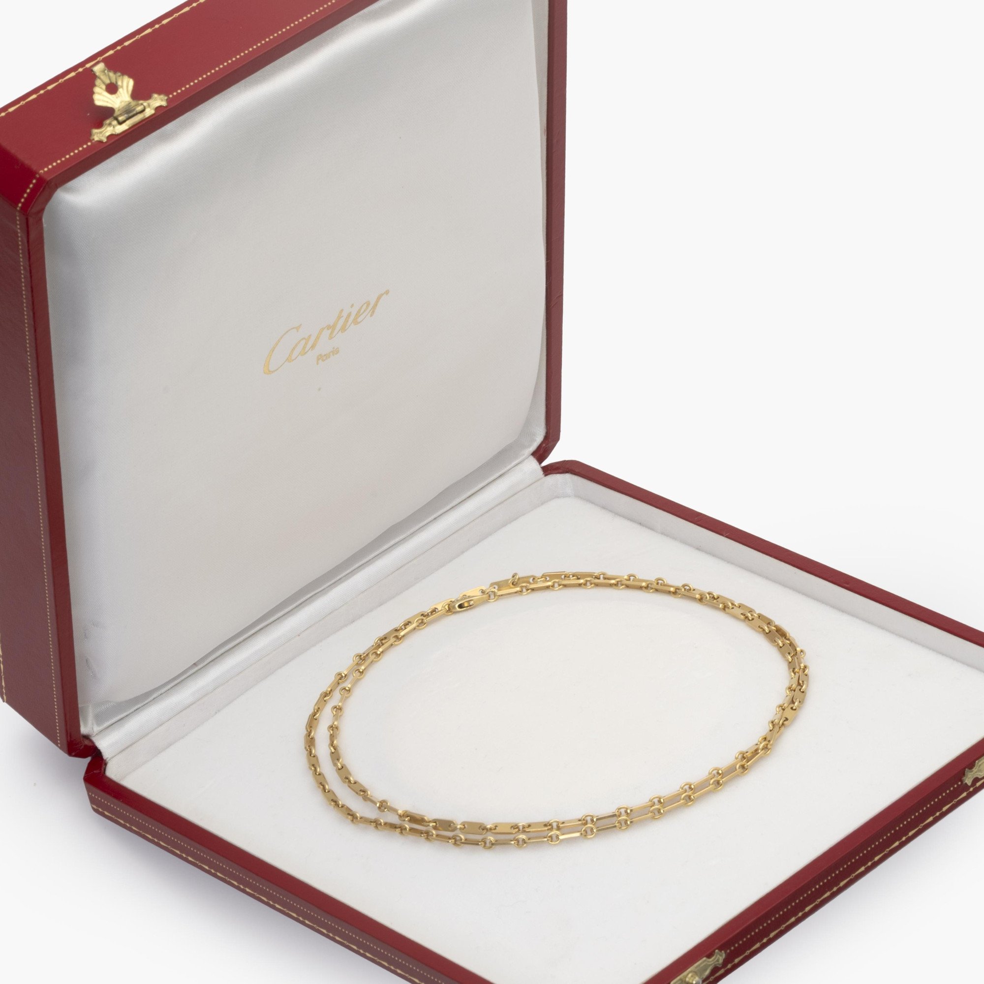 An eighteen carat yellow gold necklace ‘Fidelity’, signed Cartier, made ca 1990 and numbered. With original box.