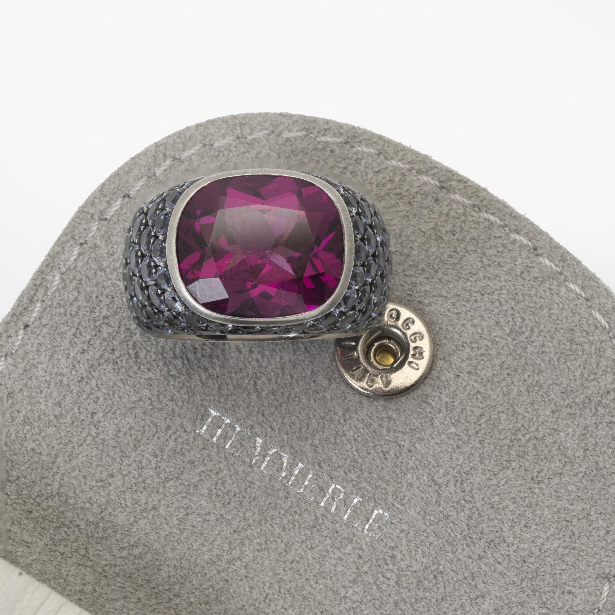 An eighteen-carat white gold and silver ring set with a very rare purple garnet and smaller purple-blue colour-change garnets. Hemmerle, Munich.