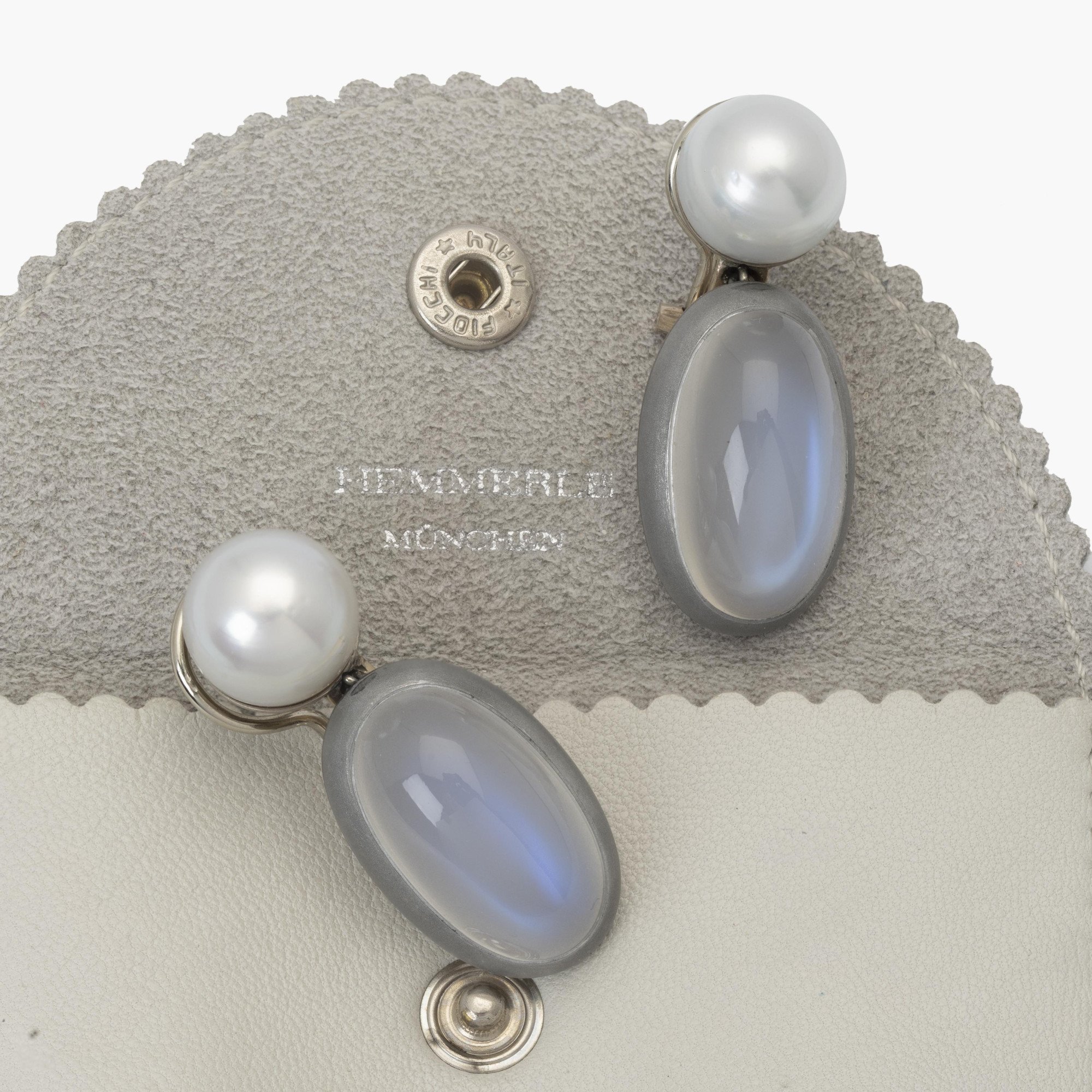 A pair of eighteen-carat white gold earrings, set with a South Sea pearl and a moonstone in aluminium. Signed Hemmerle, made in Munich. With original pouch.