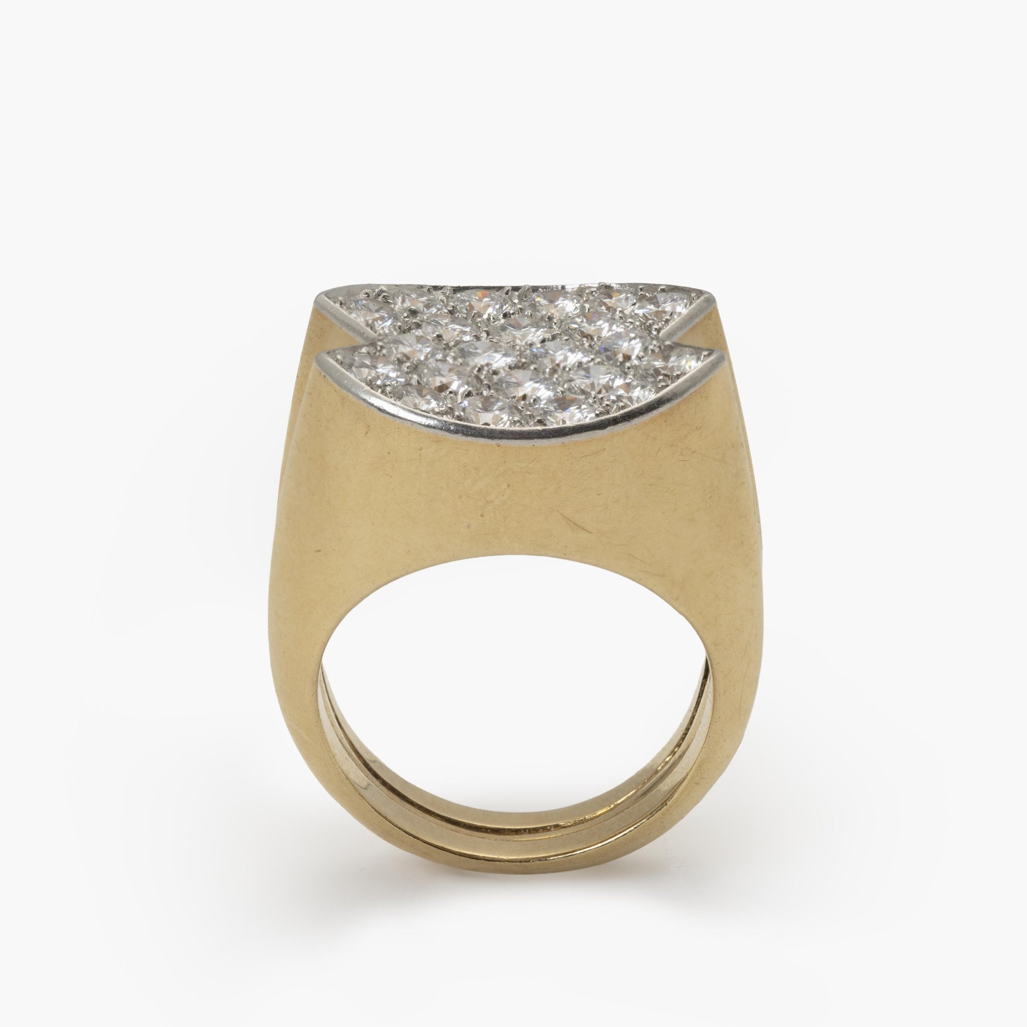 An eighteen-carat yellow gold ring, with a concave platinum top, set with brilliant-cut diamonds. Signed Cartier Paris and numbered. Made ca 1960.