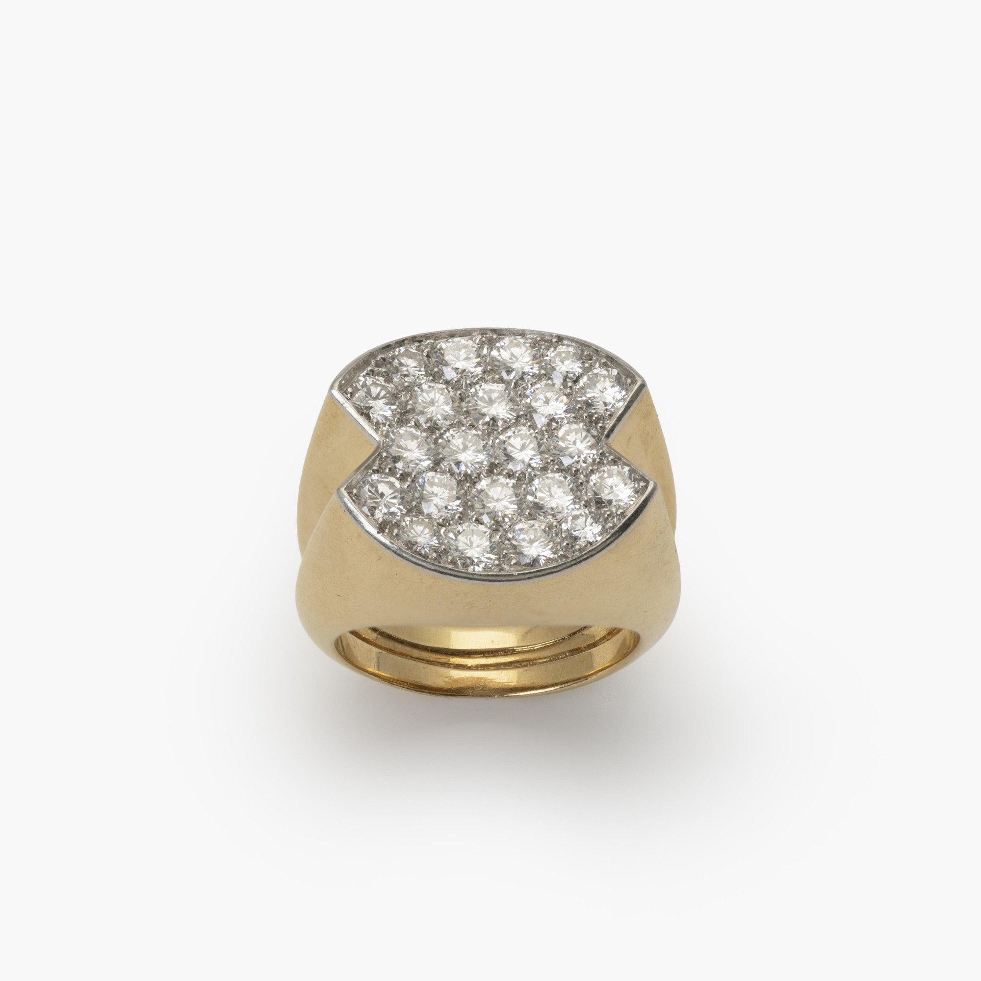 An eighteen-carat yellow gold ring, with a concave platinum top, set with brilliant-cut diamonds. Signed Cartier Paris and numbered. Made ca 1960.