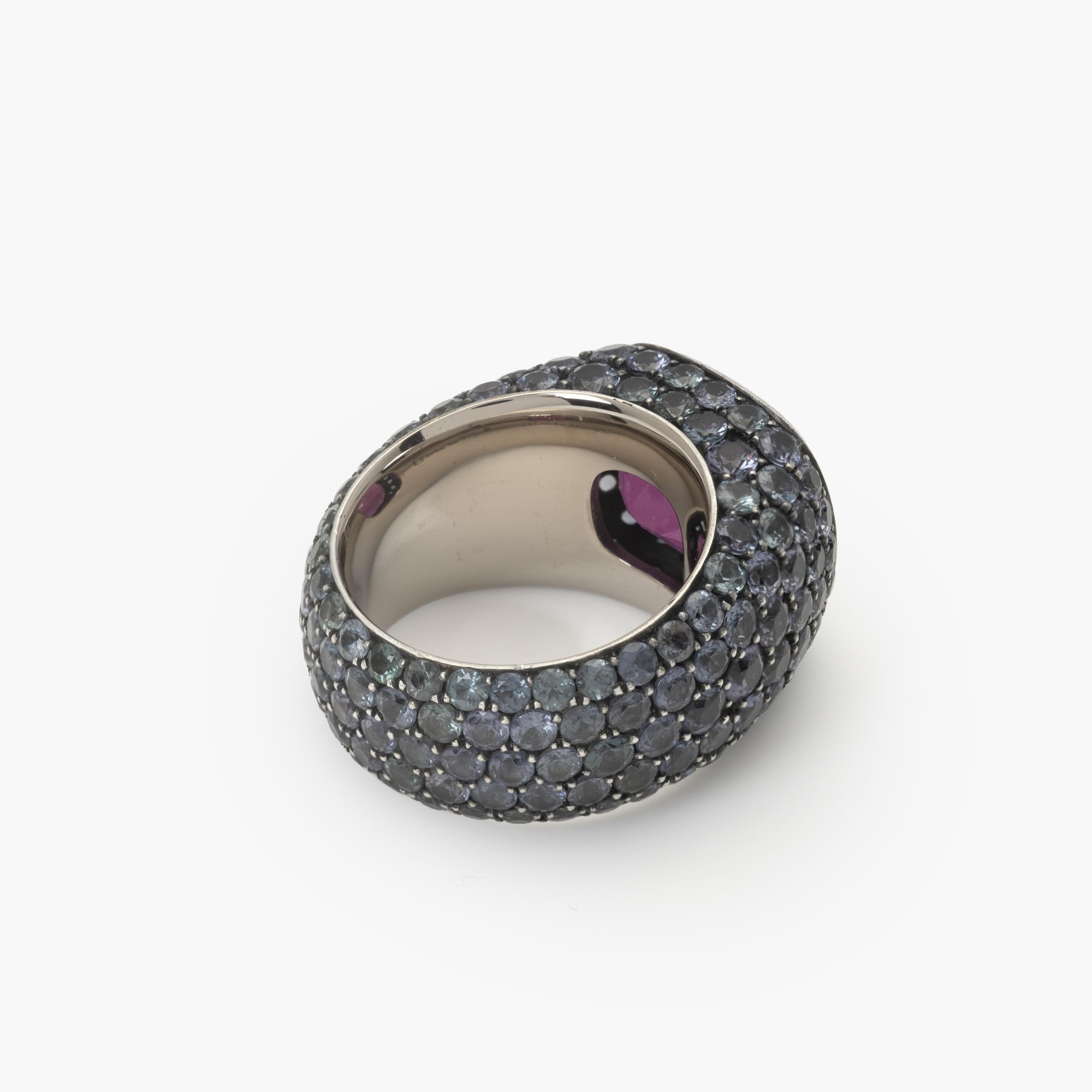 An eighteen-carat white gold and silver ring set with a very rare purple garnet and smaller purple-blue colour-change garnets. Hemmerle, Munich.