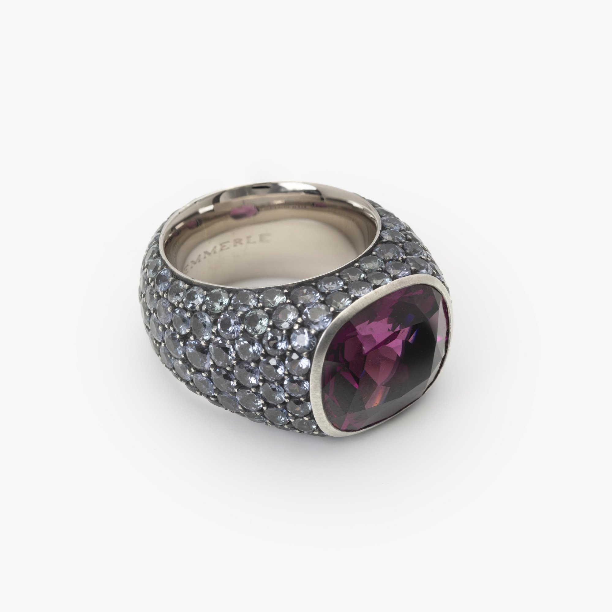 An eighteen-carat white gold and silver ring set with a very rare purple garnet and smaller purple-blue colour-change garnets. Hemmerle, Munich.