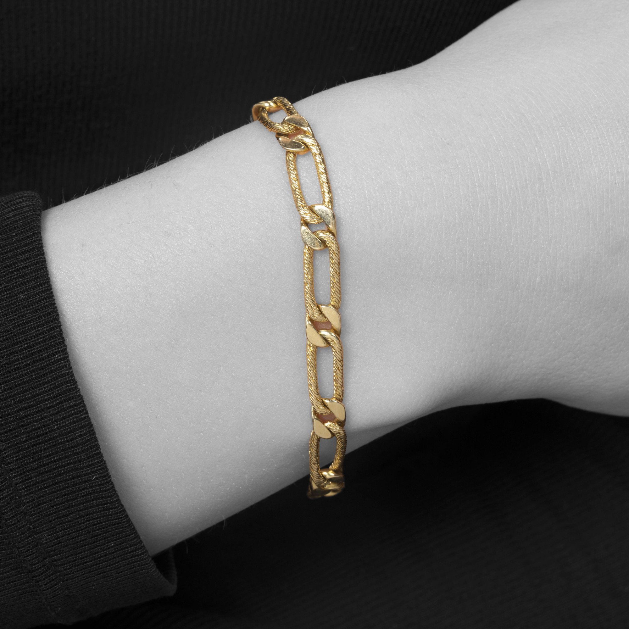 An eighteen-karat yellow gold bracelet of figaro link design. Signed Fred, Paris, made ca 1970. With maker’s mark of Georges Lenfant, Paris.