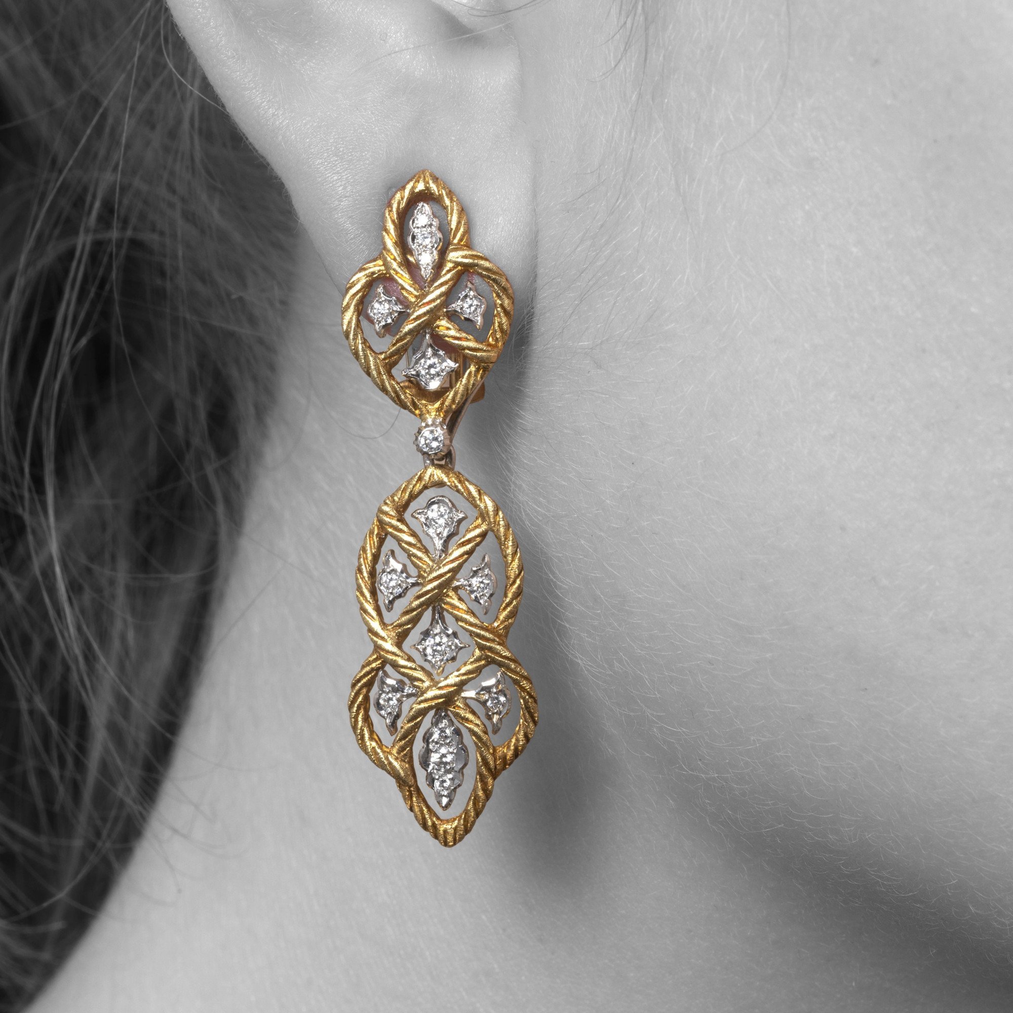 A pair of eighteen-carat yellow gold clip-earrings with detachable pendants, model ‘Étoilée’, set with diamonds. Signed Gianmaria Buccellati, Italy.