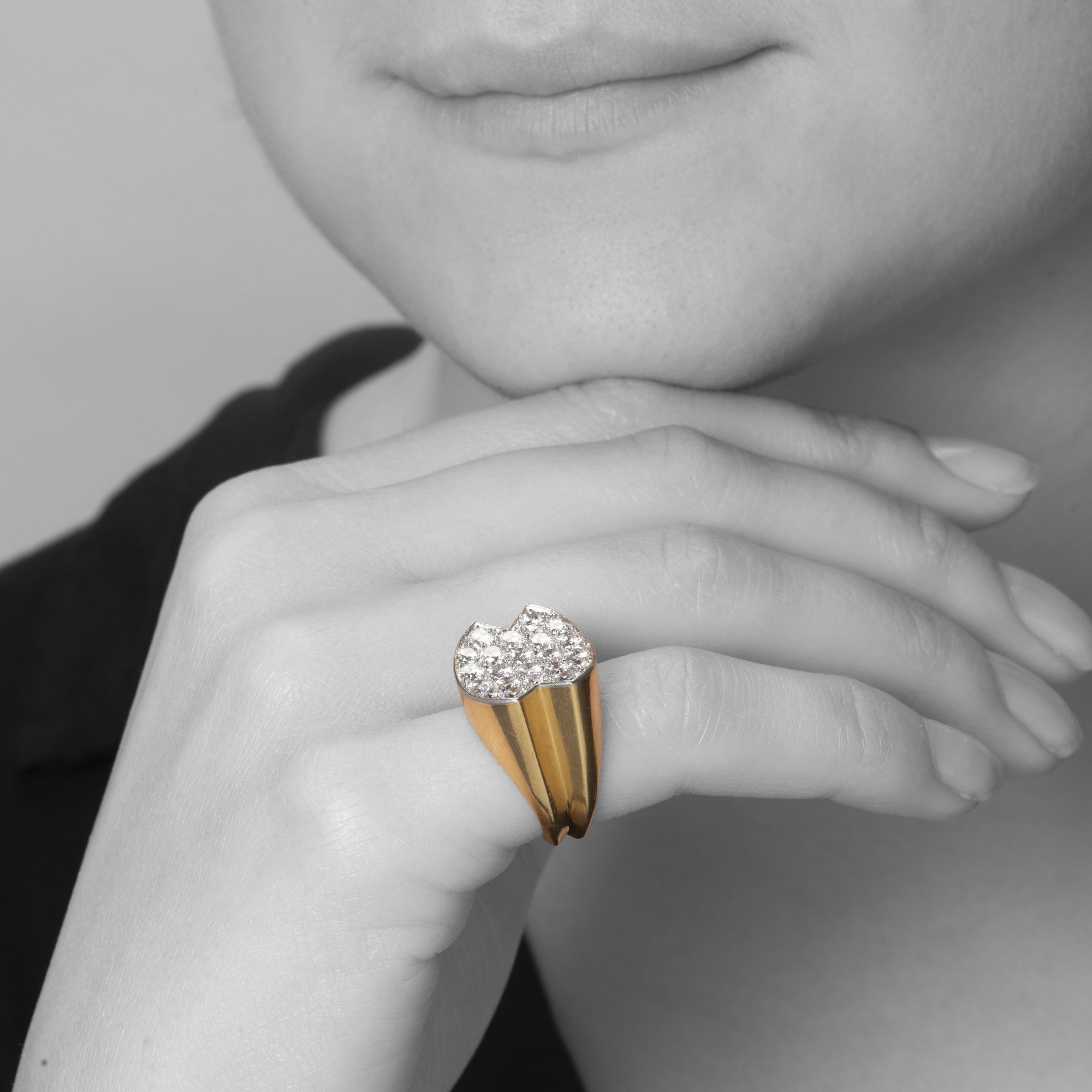 An eighteen-carat yellow gold ring, with a concave platinum top, set with brilliant-cut diamonds. Signed Cartier Paris and numbered. Made ca 1960.