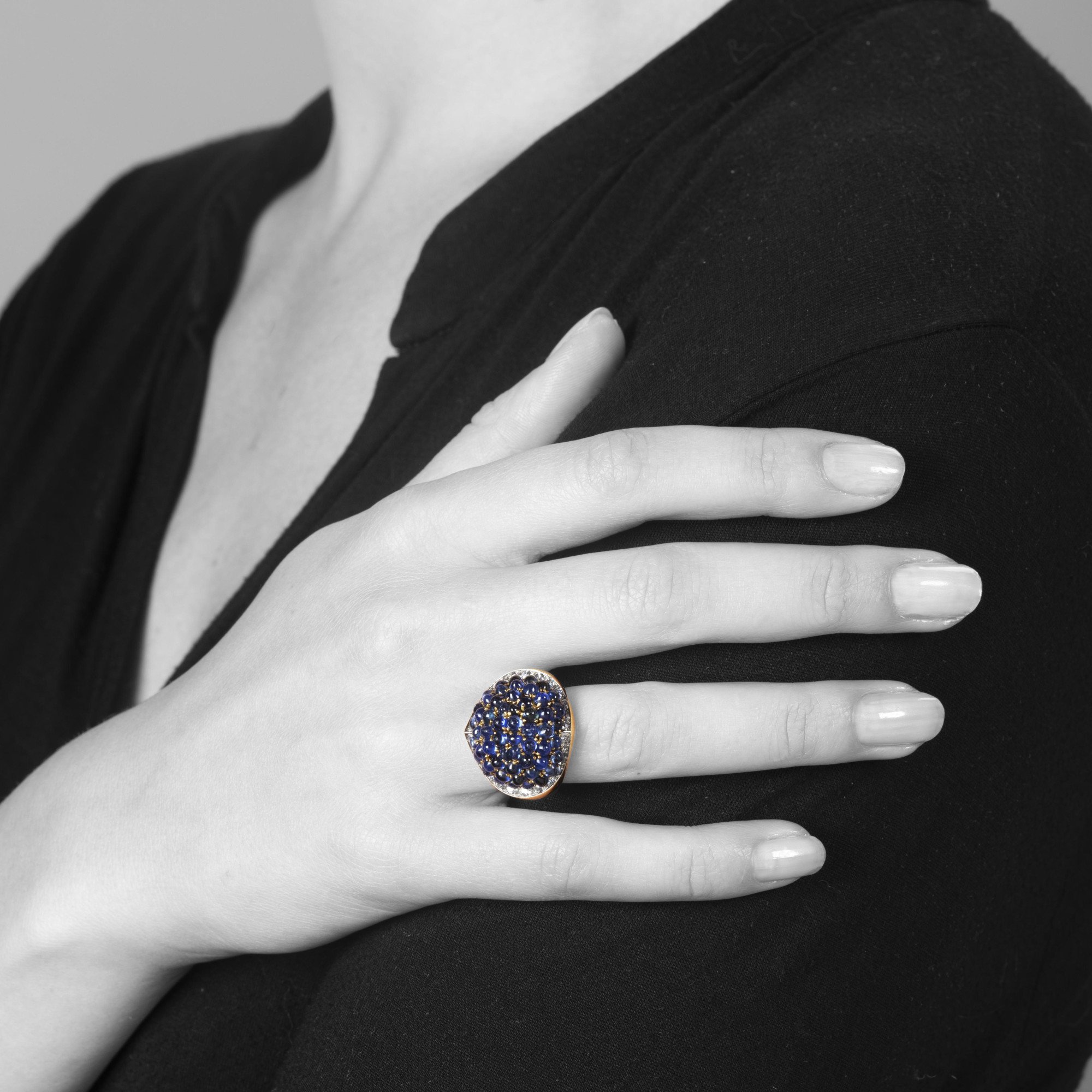 An eighteen carat yellow gold and platinum ring, pavé set with sapphires, surrounded by brilliant-cut diamonds. Signed Van Cleef & Arpels and numbered.