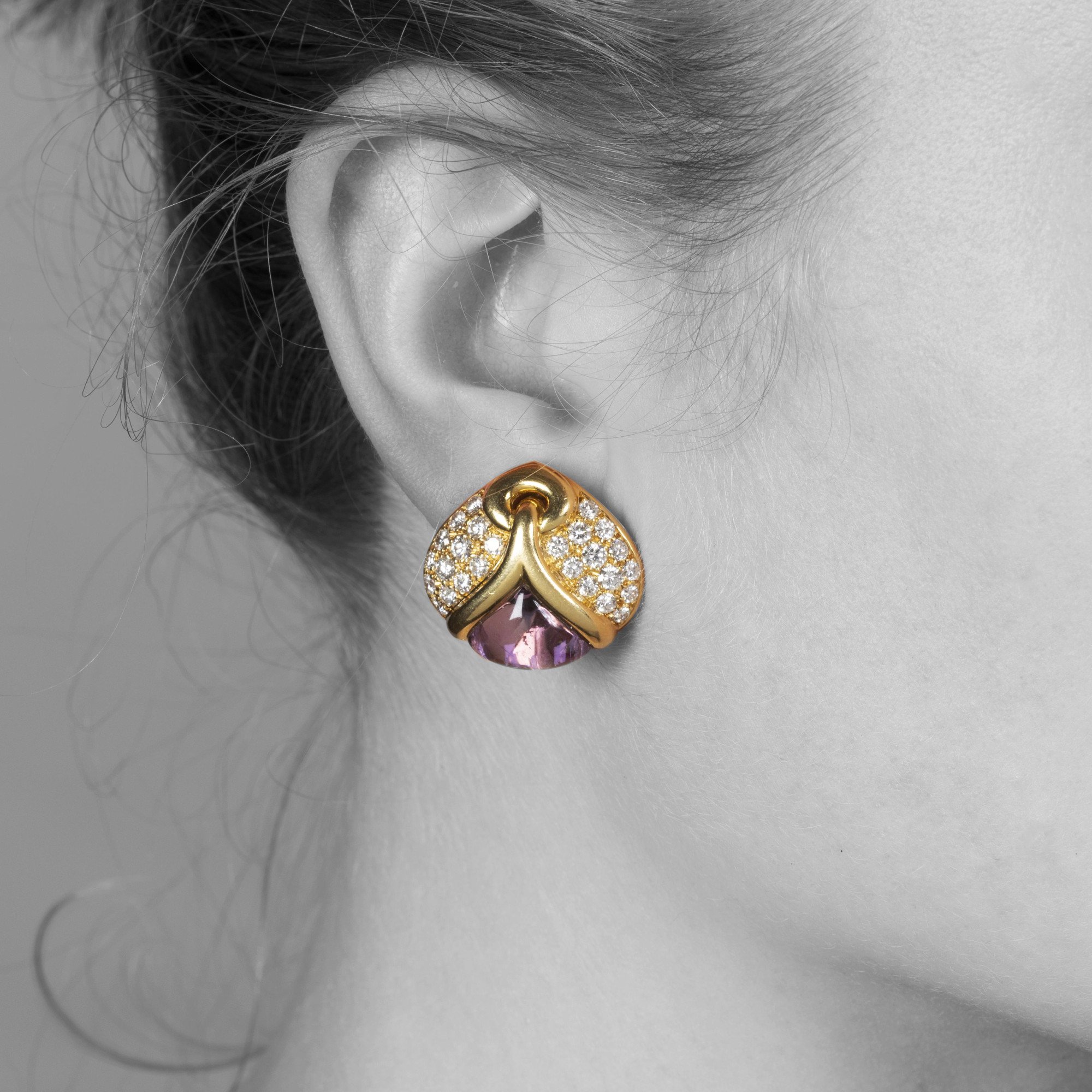 A pair of eighteen carat yellow gold clip earrings, each set with amethyst and diamonds. Signed Bvlgari, made in Rome, Italy and dated 1989.