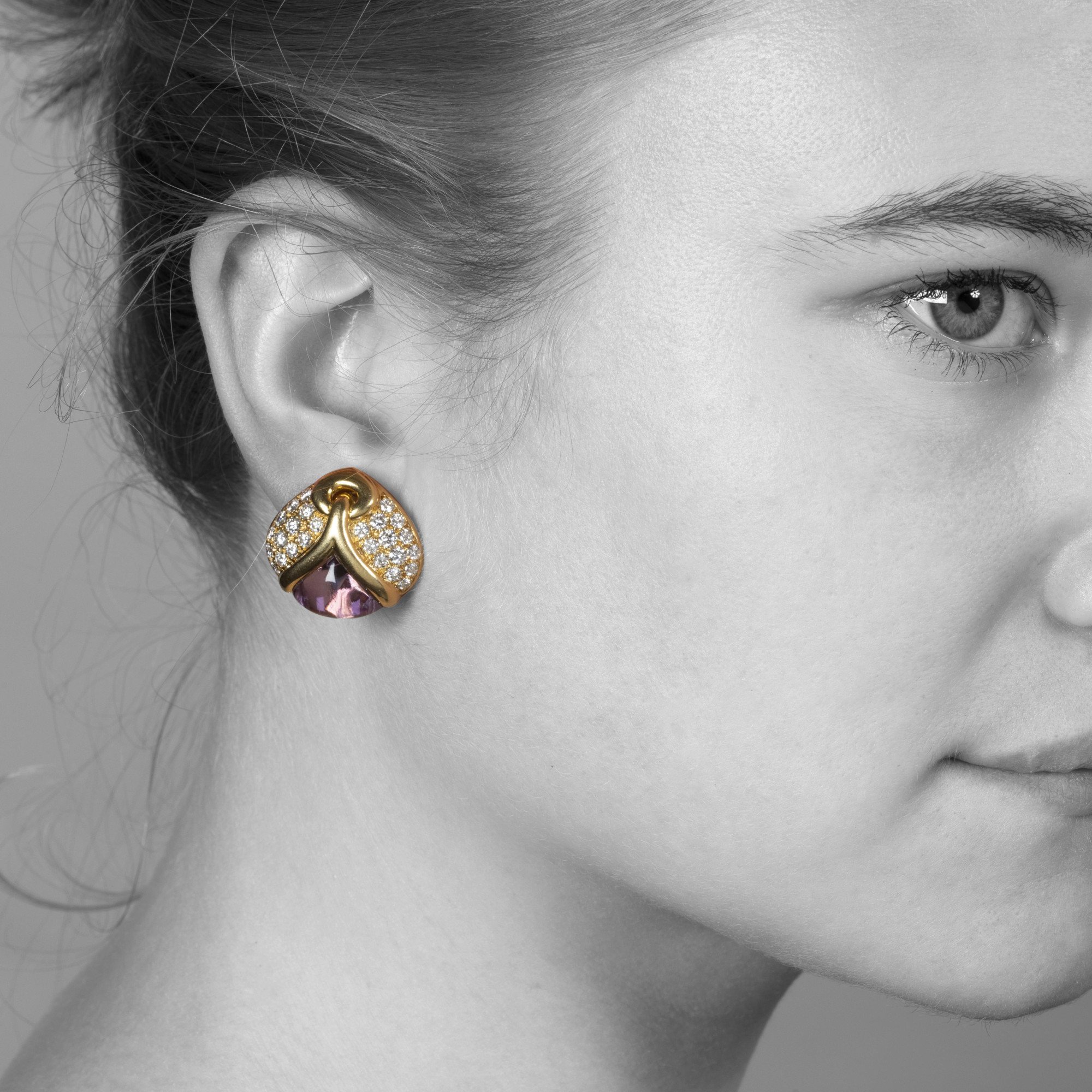A pair of eighteen carat yellow gold clip earrings, each set with amethyst and diamonds. Signed Bvlgari, made in Rome, Italy and dated 1989.