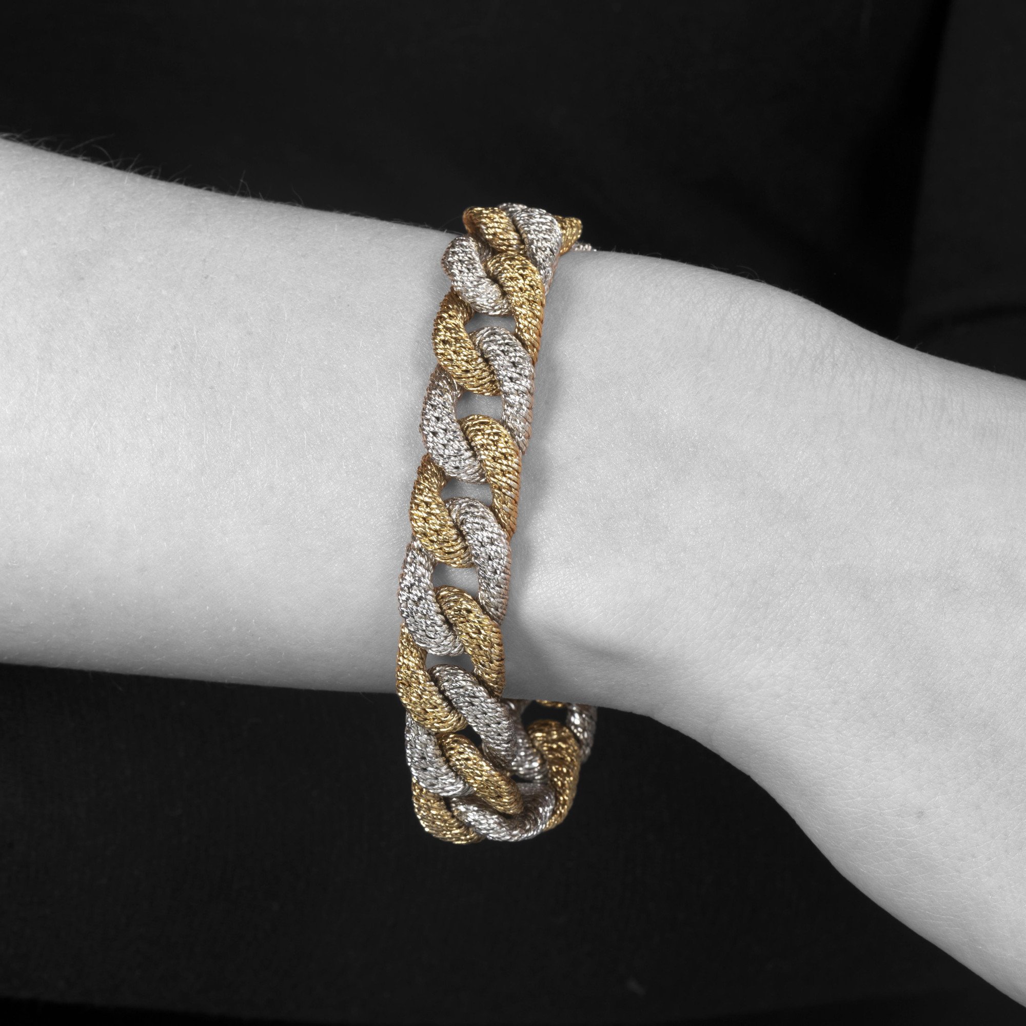 An eighteen carat white and yellow gold curb link bracelet. With maker’s mark of George Lenfant, Paris. Made circa 1970.
