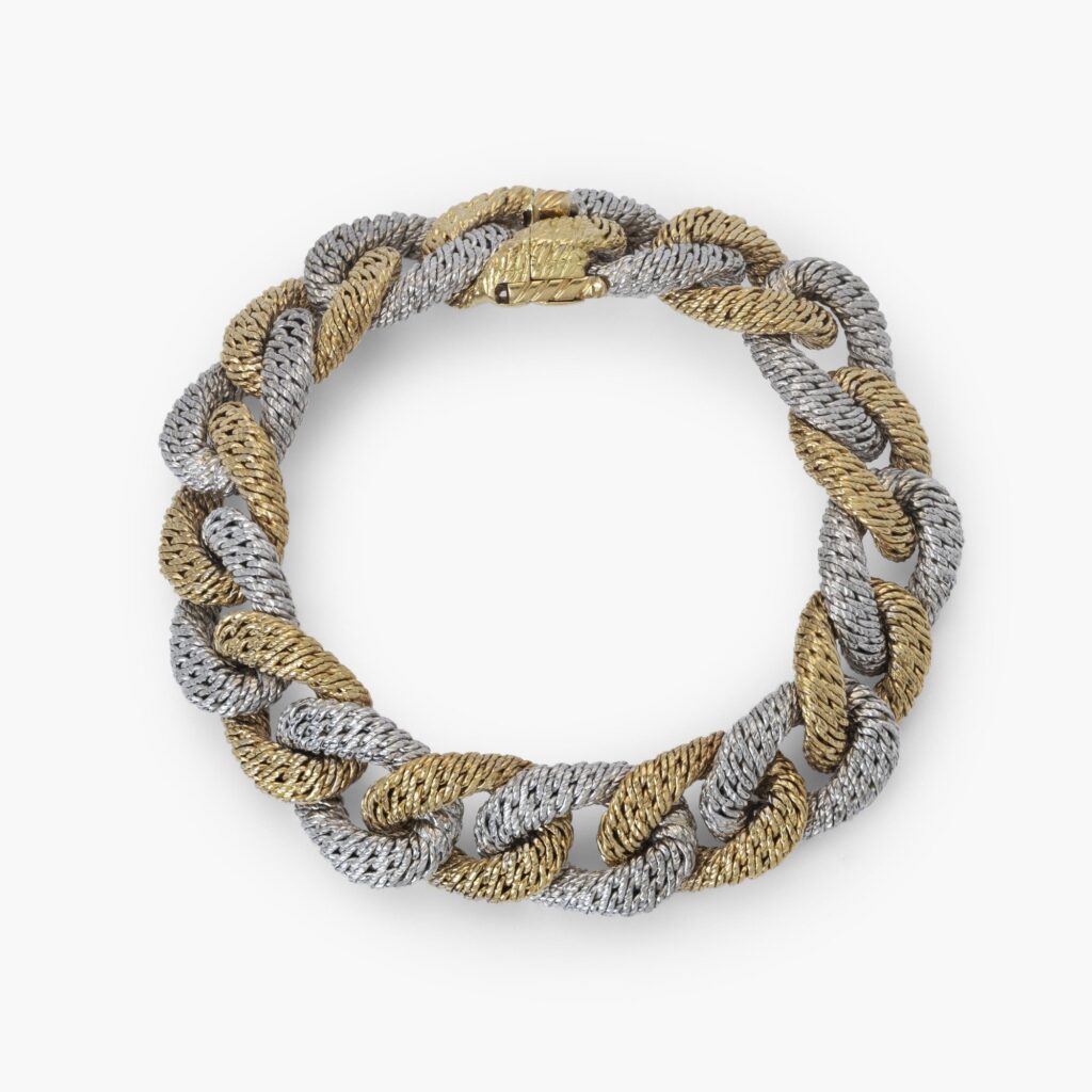 An eighteen carat white and yellow gold curb link bracelet. With maker’s mark of George Lenfant, Paris. Made circa 1970.