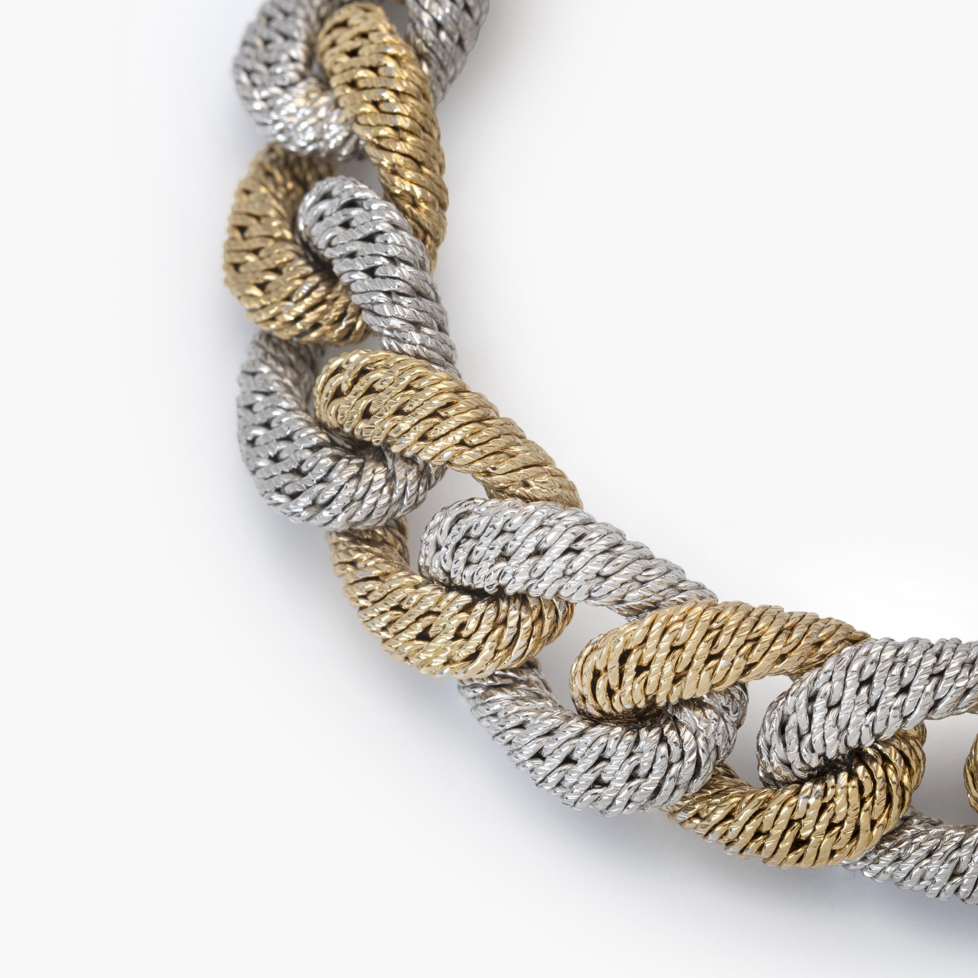 An eighteen carat white and yellow gold curb link bracelet. With maker’s mark of George Lenfant, Paris. Made circa 1970.