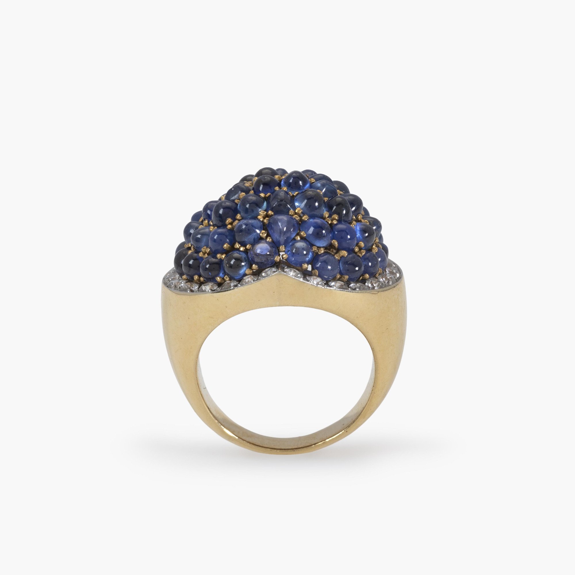 An eighteen carat yellow gold and platinum ring, pavé set with sapphires, surrounded by brilliant-cut diamonds. Signed Van Cleef & Arpels and numbered.