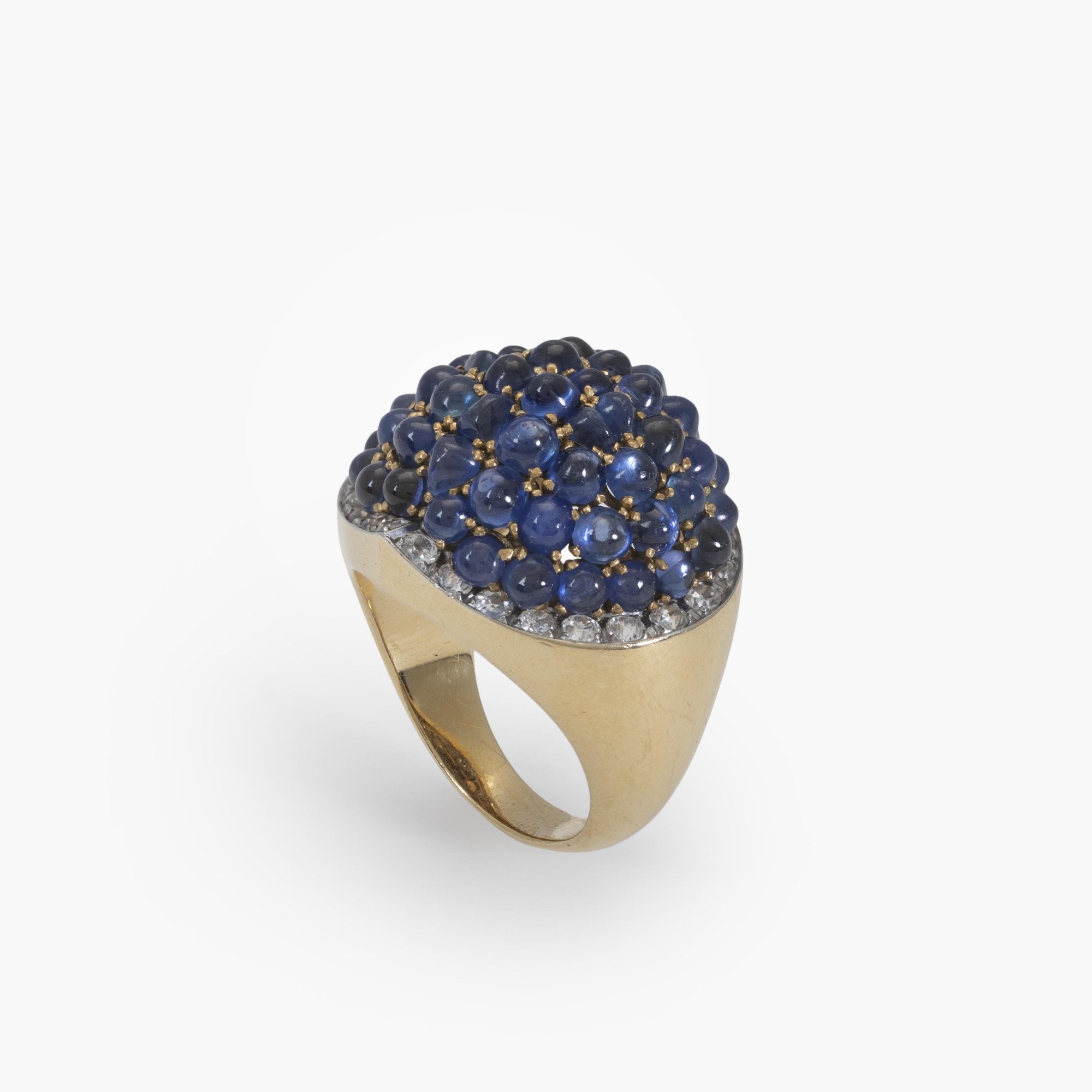 An eighteen carat yellow gold and platinum ring, pavé set with sapphires, surrounded by brilliant-cut diamonds. Signed Van Cleef & Arpels and numbered.